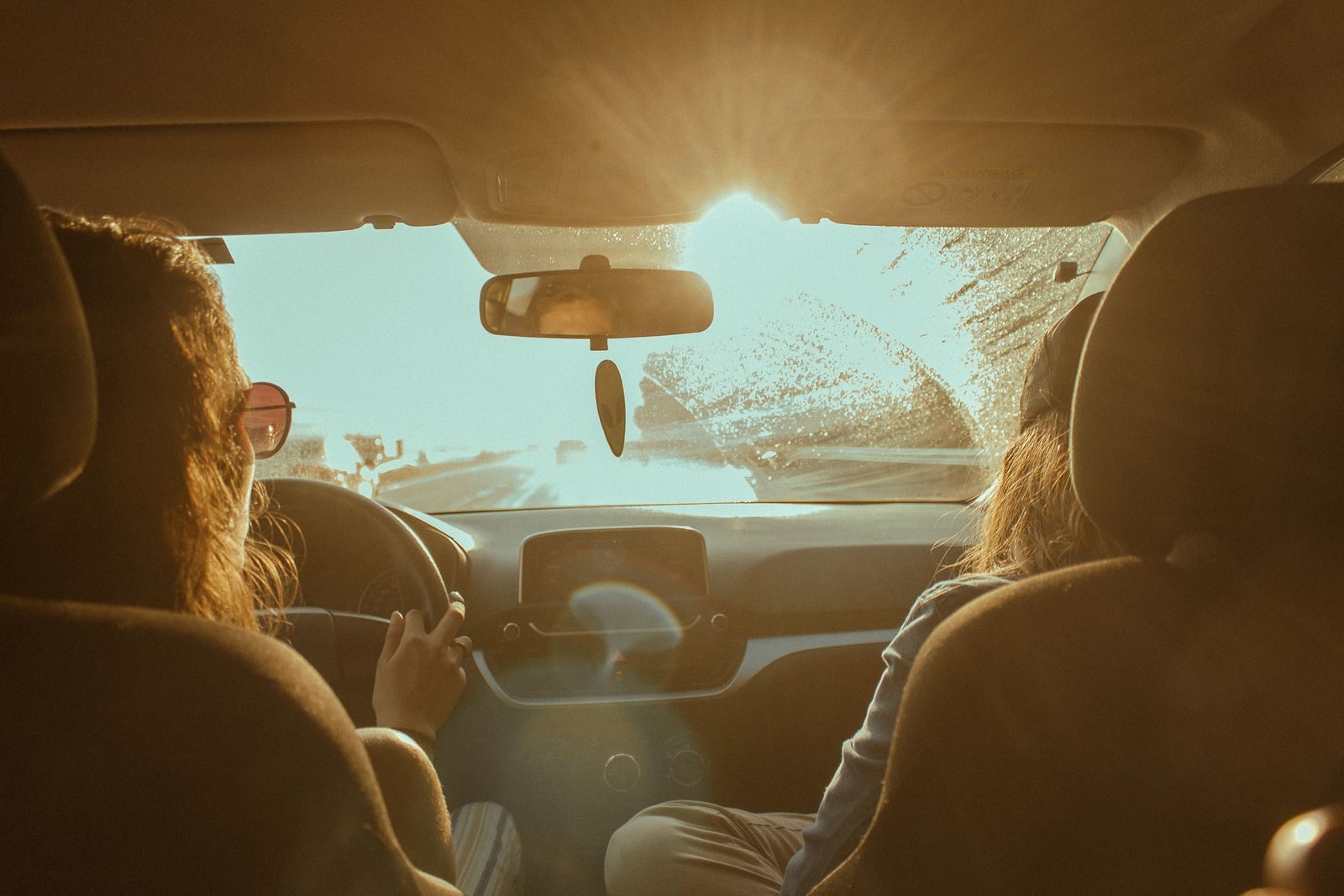 Intense sun glaring through a car windshield